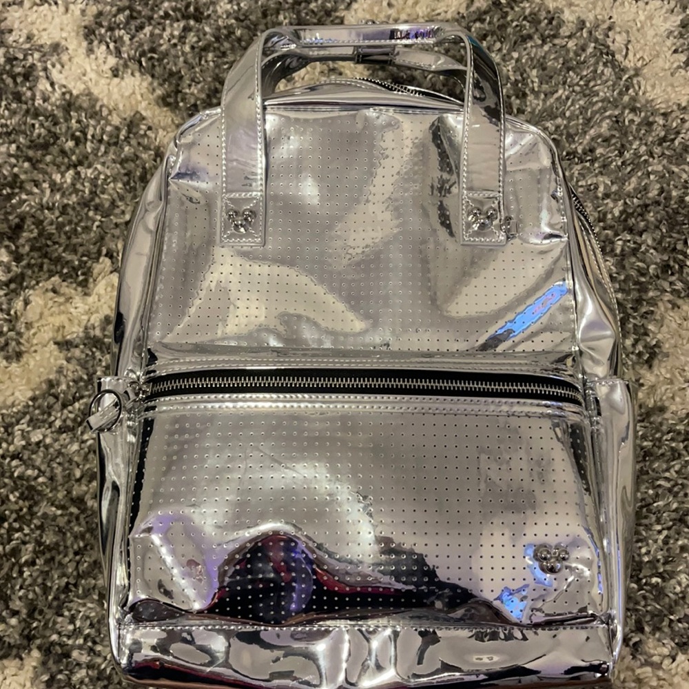 Limited edition shiny silver Disney backpack. NEVER USED